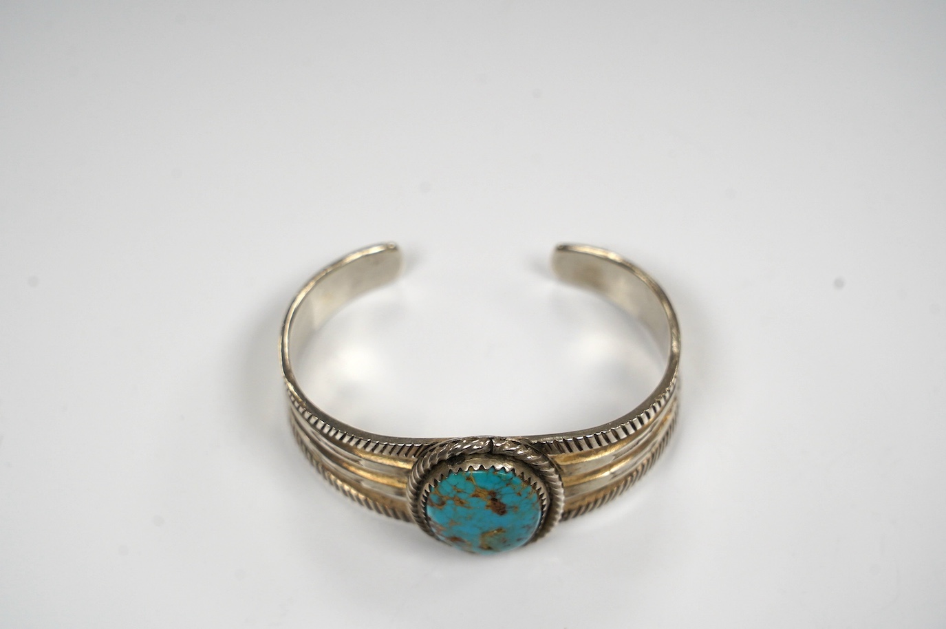 A Navaho? turquoise set white metal open bangle. Condition - fair